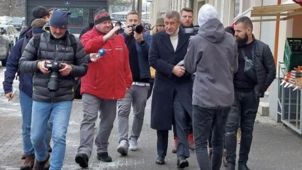 Foto z FB Martina Půty. Jeden ze zájemců o Hrad v Liberci před nádražím mezi ochrankou a novináři.